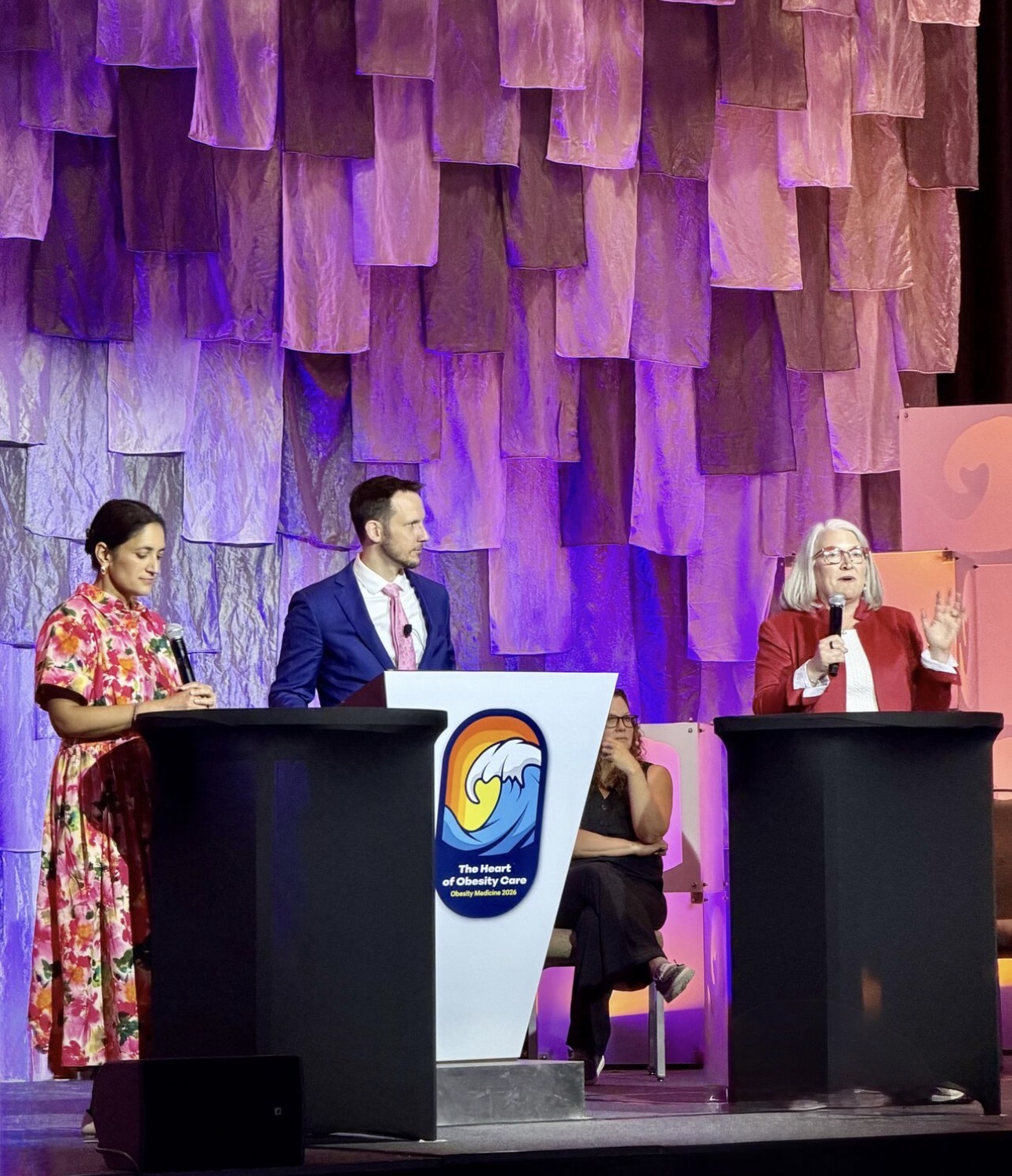 Christopher Weber, MD on stage during a plenary panel at Obesity Medicine 2026